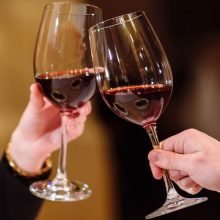 Premium Photo _ Man and woman drinking red wine_ In the picture, close-up hands with glasses_