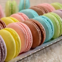 French colorful macarons on the wooden table. Closeup